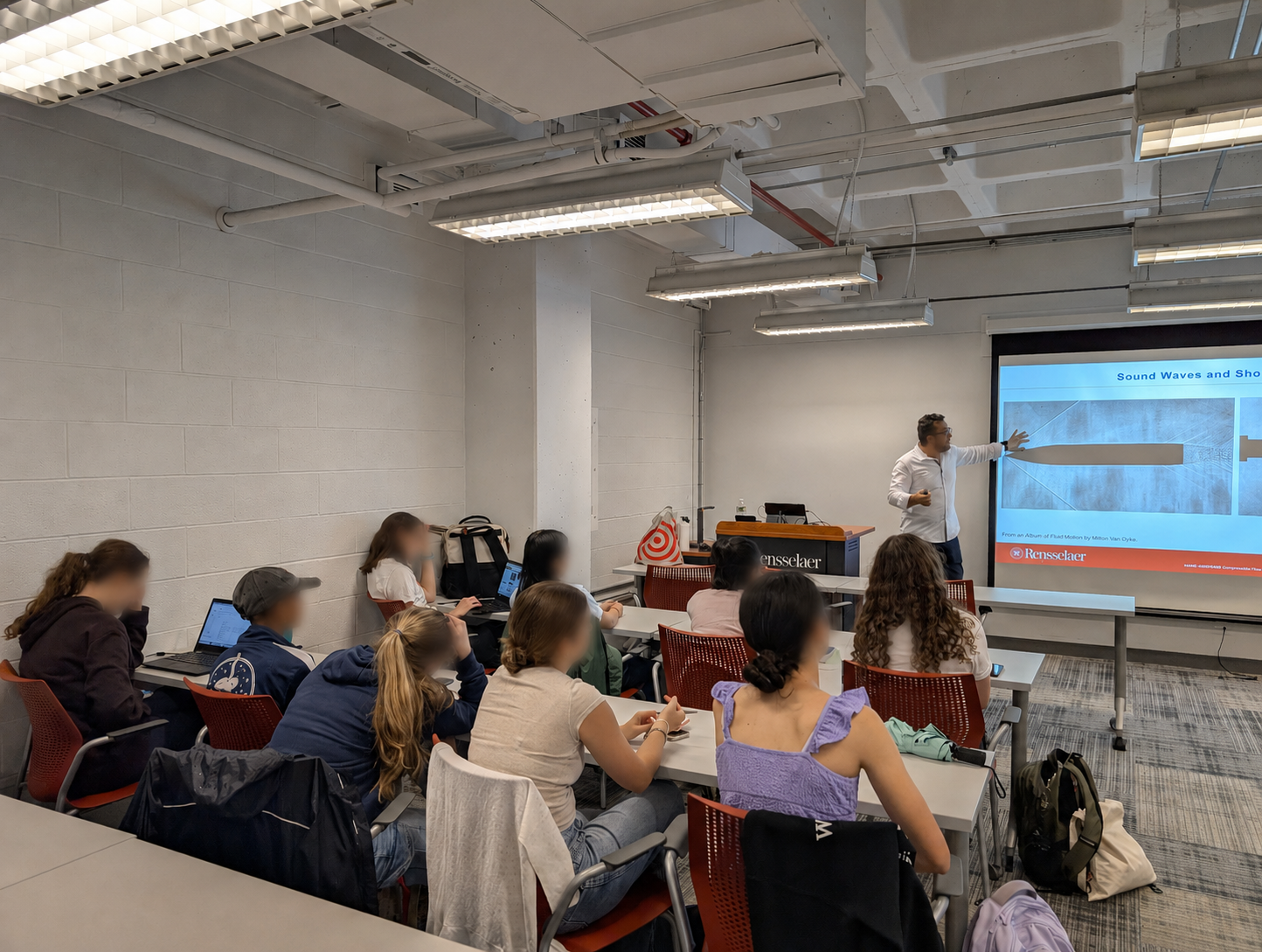 An instructor leads a Summer Program lesson for high school students.